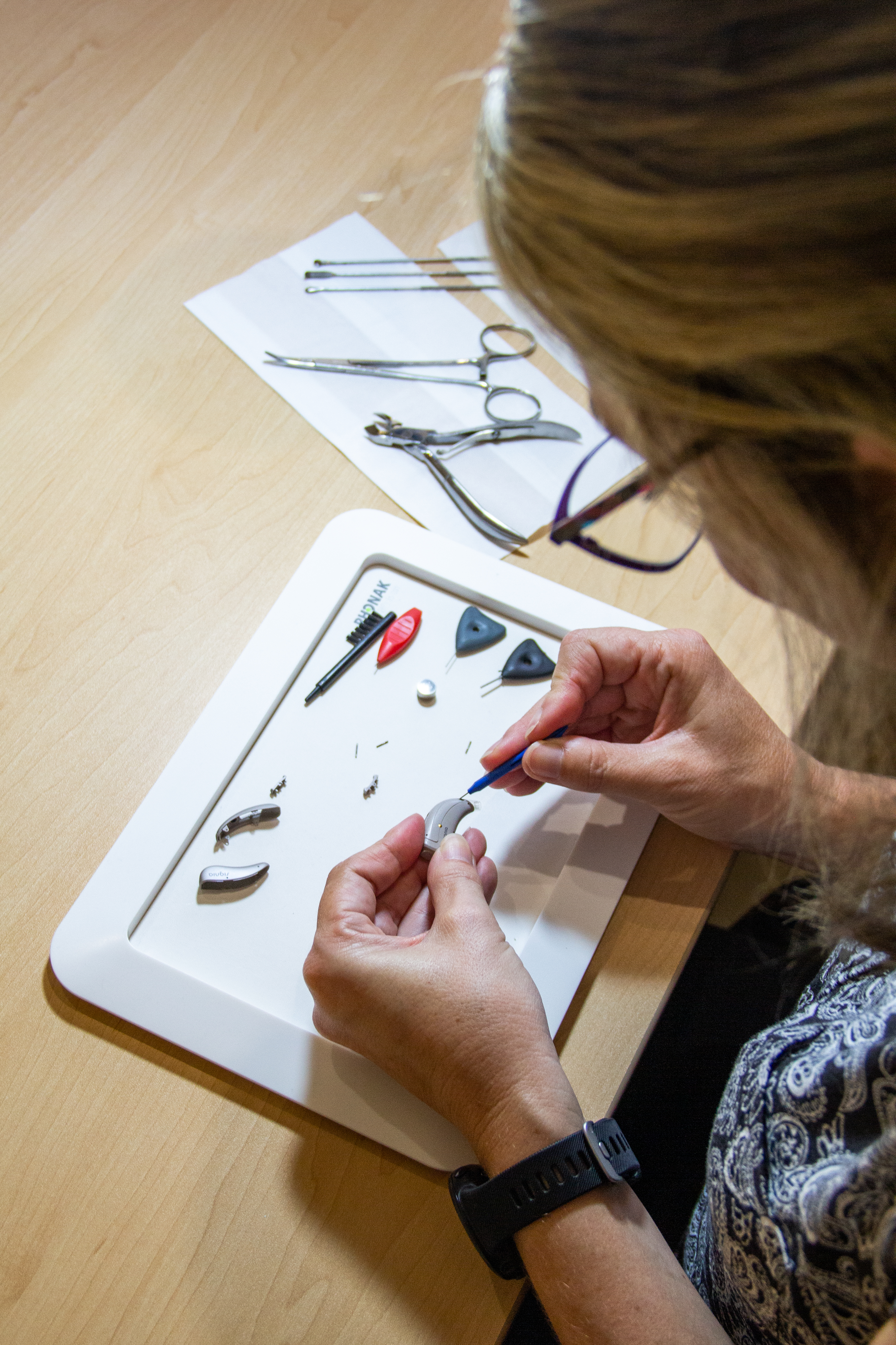 Kate-Marie doing a hearing aid repair